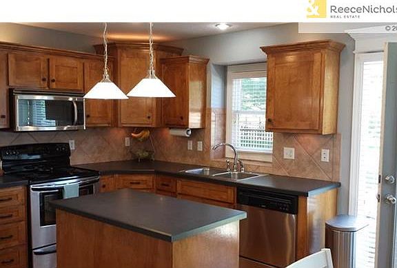 Stainless steel appliances, pendent lights and tile backsplash.  Indirect lighting above and below the cabinets as well.