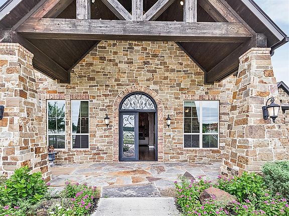 Stunning Oklahoma stone and brick facade and flagstone flooring.