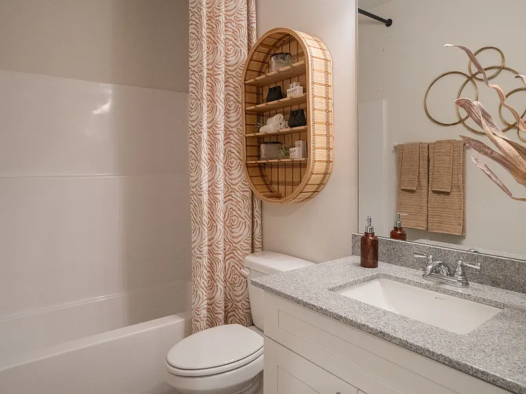 Secondary bathroom with tub shower and single vanity.