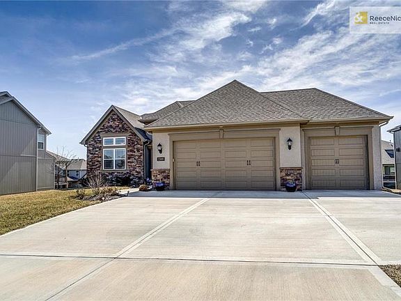 "Wyndham V" built by award winning New Mark Homes KC with Stucco & Stone Accent Exterior & 3/car garage!