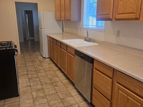 Kitchen inside front entrance - stove/oven/hood, dishwasher, fridge/freezer - all appliances less than 3 years old.