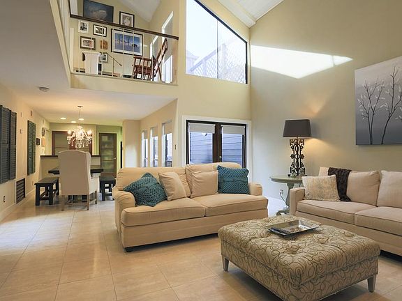 You won't be disappointed in this open floorplan with abundant natural light. This is the view of the family room looking toward the breakfast and kitchen. One of 2 atriums can be seen through the double doors on the right.