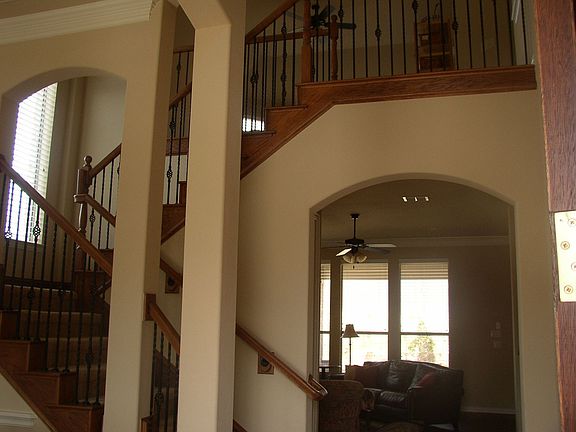 Dramatic two-story entry with iron balusters.