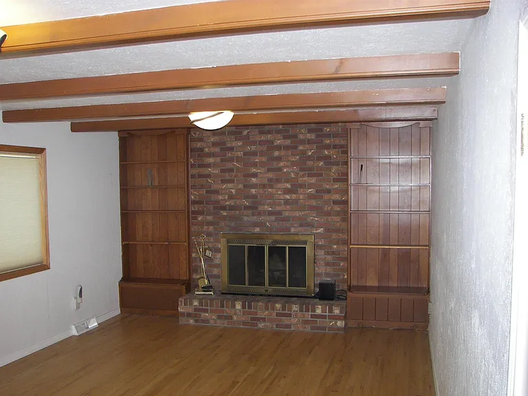 Family Room looking North to gas fireplace with bookshelves