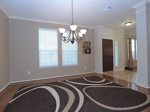 Beautiful crown molding, hardwood floors and updated fixture in the formal dining room.