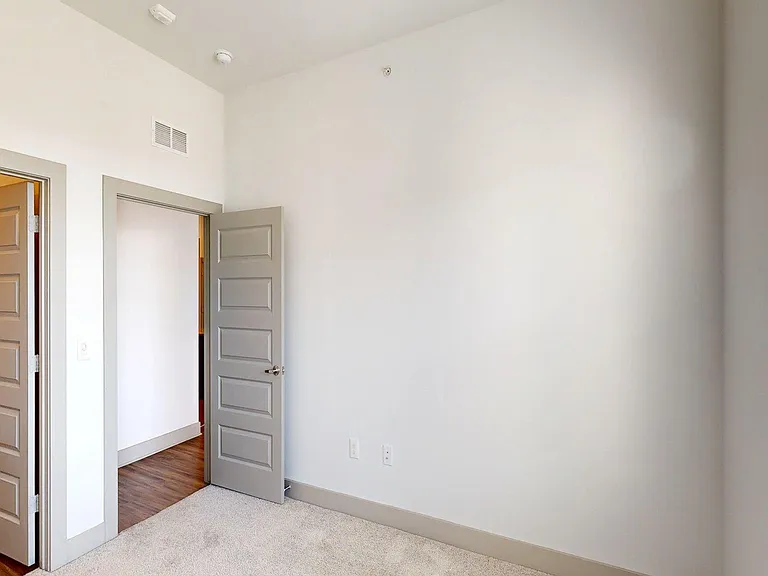 Spacious apartment Bedroom with Carpet Floor.