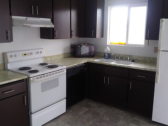 Kitchen with newly painted cabinets and new laminate flooring.