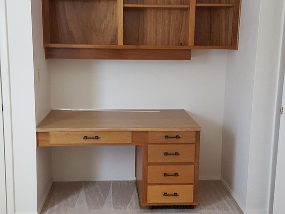 Second bedroom with two closets on each side of built-in des