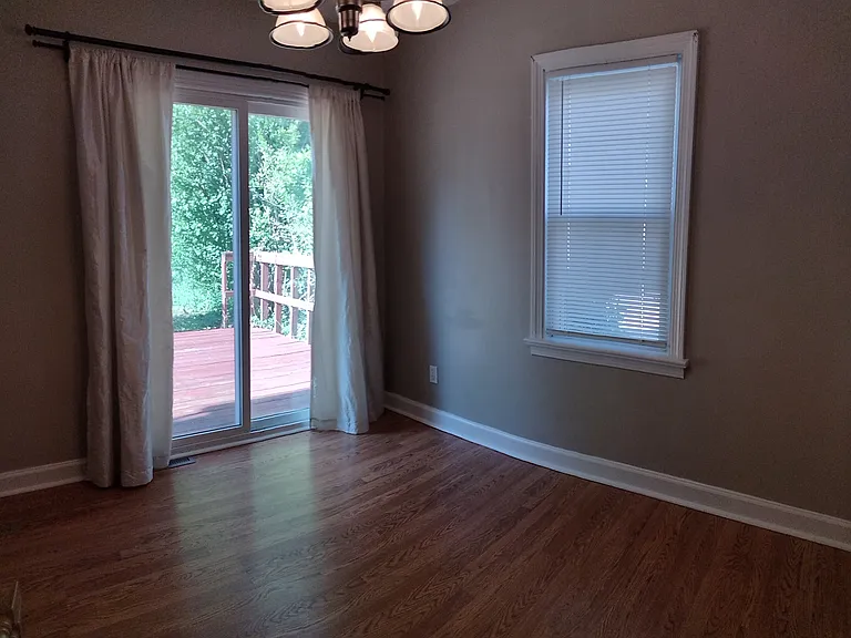 Dining room with sliding glass doors to deck and fenced-in back yard.
