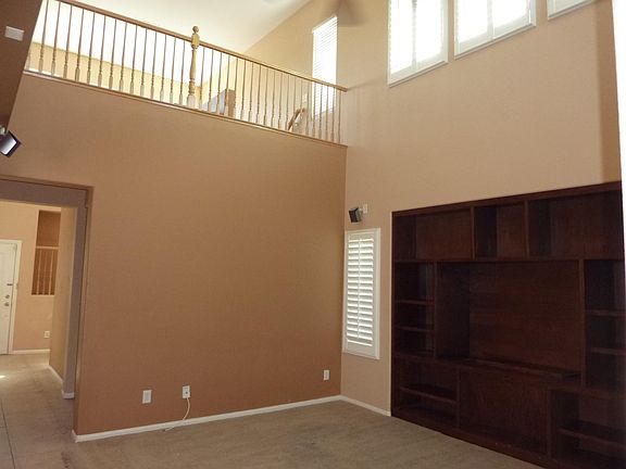 Living room with high ceiling looking onto the 2nd floor