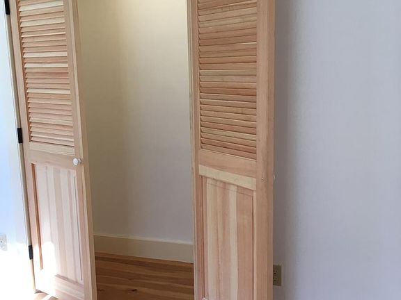 Large bright bedroom with lighted closet