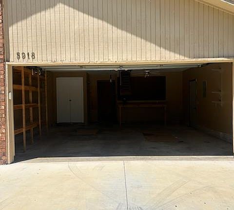 Spacious garage with storage and work bench.
