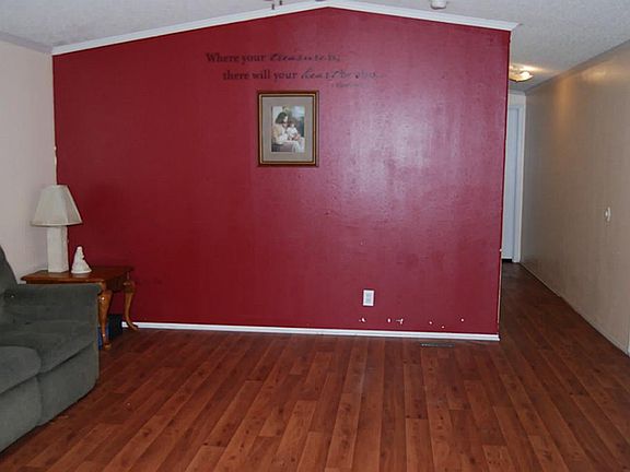 Over sized furniture will work here!!! Living Room features high ceilings, wood laminate flooring & 