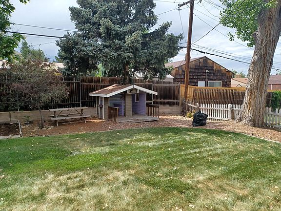 A playhouse built around a pine tree