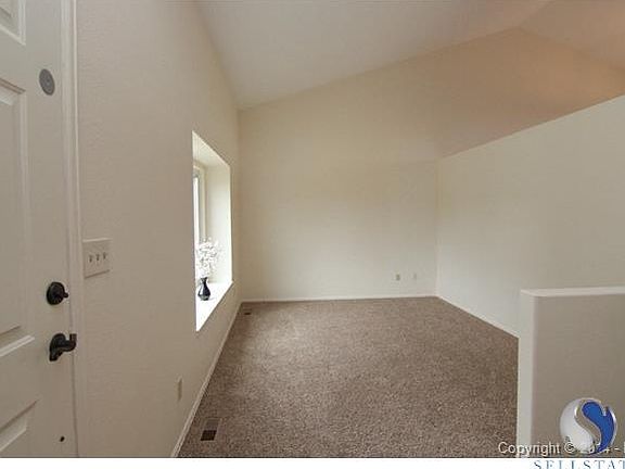 Main level living room - built up wall and large picture window.