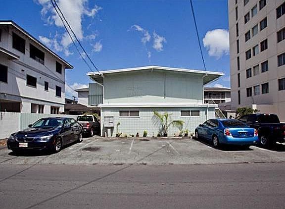 view of building, this unit is the front ground floor unit, belongs with the tandem stall showing 2 cars on the left