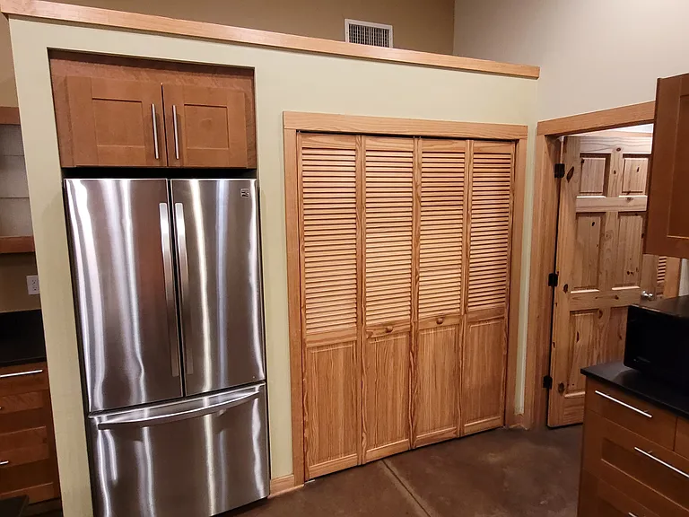 From the left, coffee station, fridge, pantry and mudroom / laundry room door.