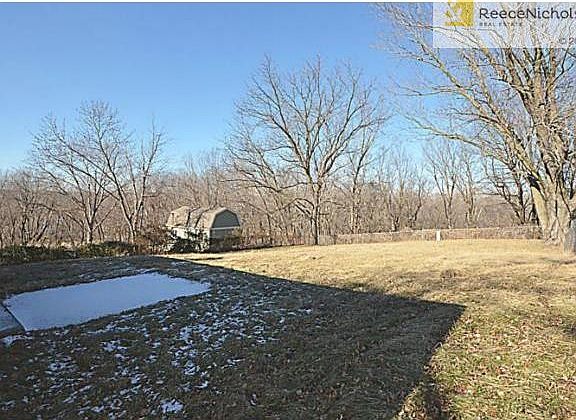 Fenced Backyard surrounded by woods