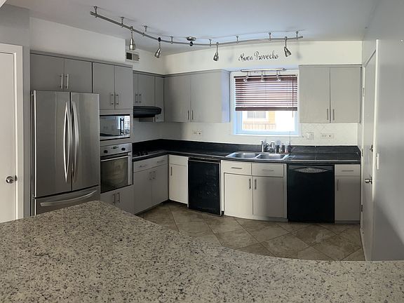 Plenty of Storage (cabinets, pantry closet, as well as under island) Appliances: fridge, microwave, oven, stove, dishwasher, and separate beverage fridge.