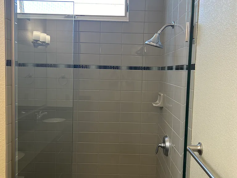 Walk in shower with window and bench seat
