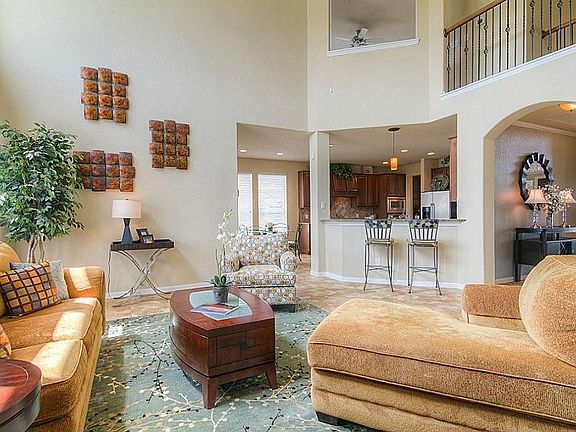 Additional view of the Family Room which features 18” tile flooring, recessed lighting, crown molding, and gas fire place.