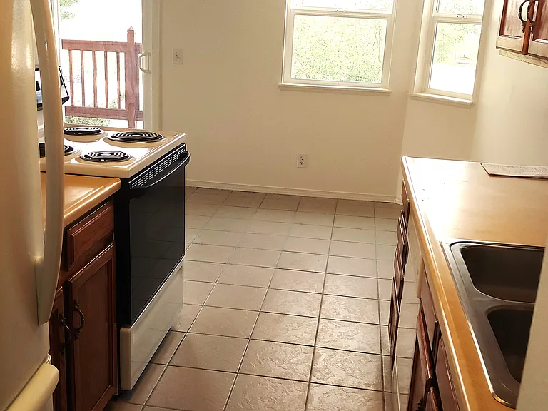 Kitchen Looking Towards Dining Area with Ceiling Fan