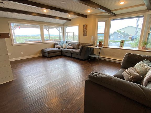 Large windows in family room look out to Skagit Bay, Olympic Mountains and both Whidbey and Camano Islands.