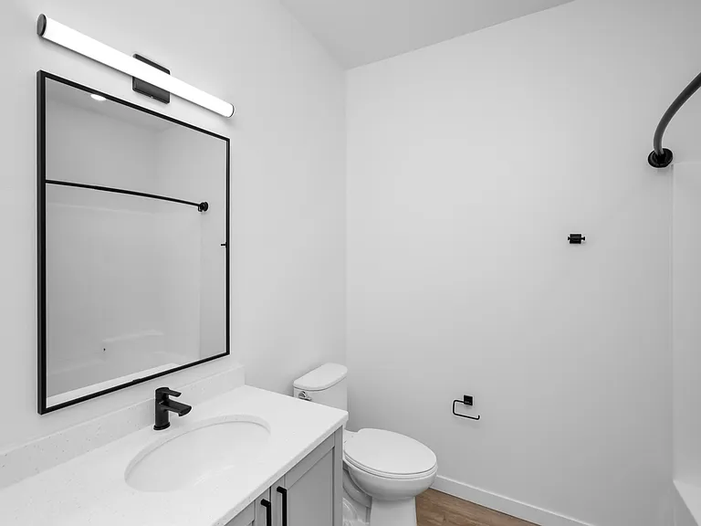 Sleek modern bathroom with elegant fixtures, large mirror, and minimalist design. Sleek modern bathroom with elegant fixtures, large mirror, and minimalist design.