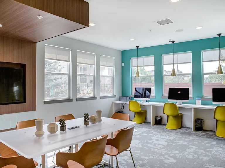 Avia Lowry's cyber lounge with Macbooks and a meeting space for residents to work from home.