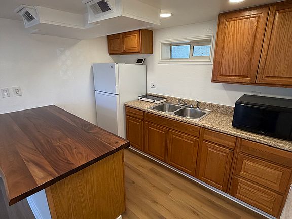 Freshly remodeled Kitchen island with new fridge. Microwave and cooking plate included.