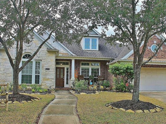 This home offers a beautiful brick and stone elevation with front porch, porte cochere extension over the garage and mature trees and landscape.