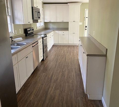 Updated kitchen with double sink, eat-in area, and natural light.