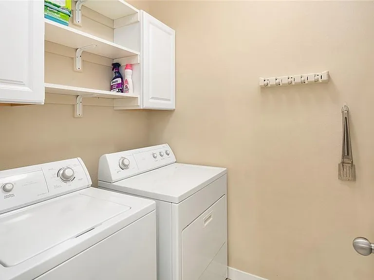 Laundry area with additional storage along both walls