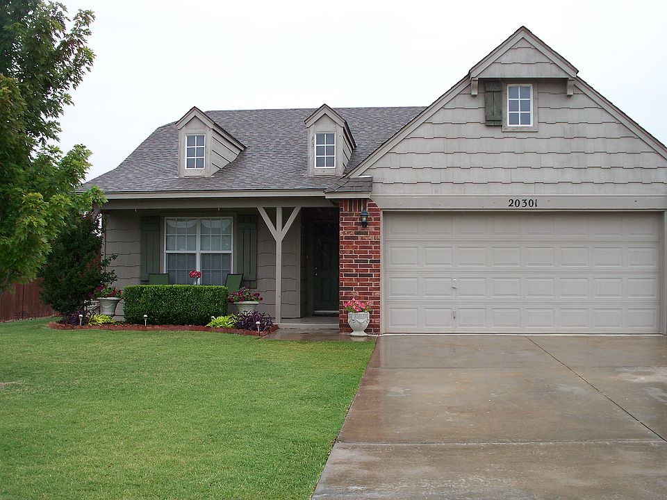 Exterior front landscaped, covered porch, 2 car garage