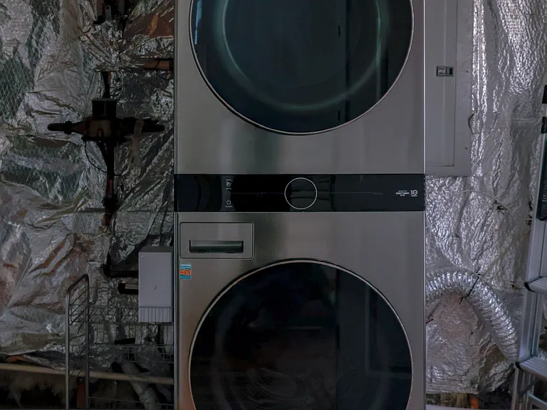 Convenient in-home laundry featuring full-size stacked washer and dryer.