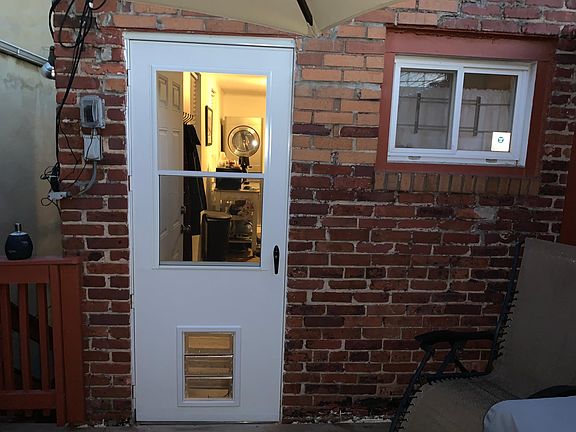 Entrance, storm door installed with pet door