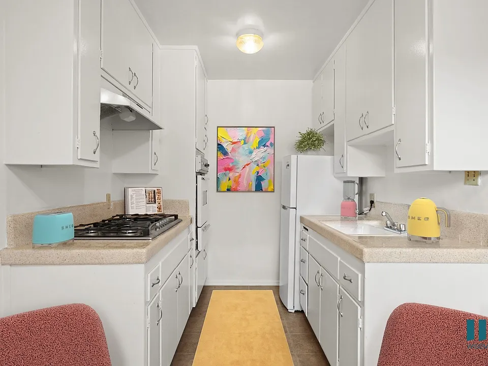 Kitchen with a Refrigerator, Range Stovetop, and Oven
