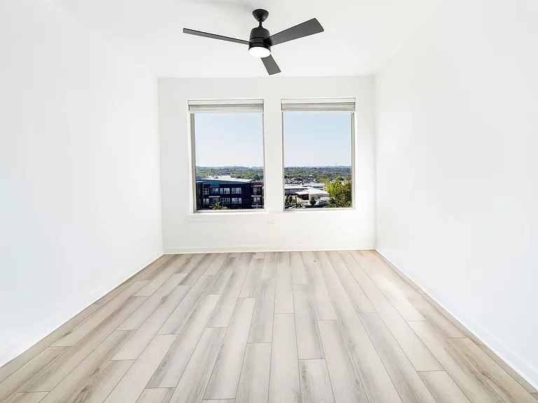 A light-filled bedroom at Modera Nations in Nashville offers calming views, clean lines, and a flexible layout designed for restful, everyday living.