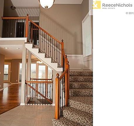 All new tiled entry with rod iron spindles