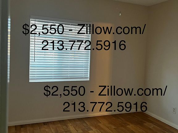 Front bedroom with wood laminate flooring and closet