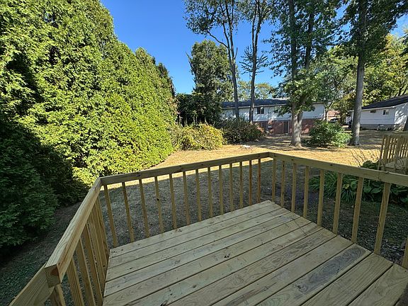 Deck off kitchen with view of backyard