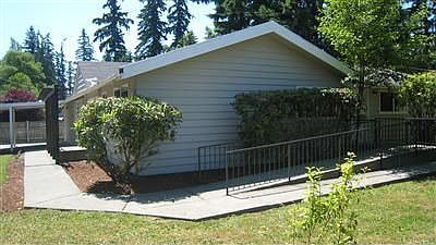 Large corner lot with ramps leading to front & side entrances.