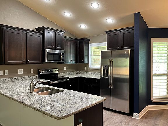 All kitchen appliances included as pictured, with granite counters offering seating options for eat-in kitchen bar