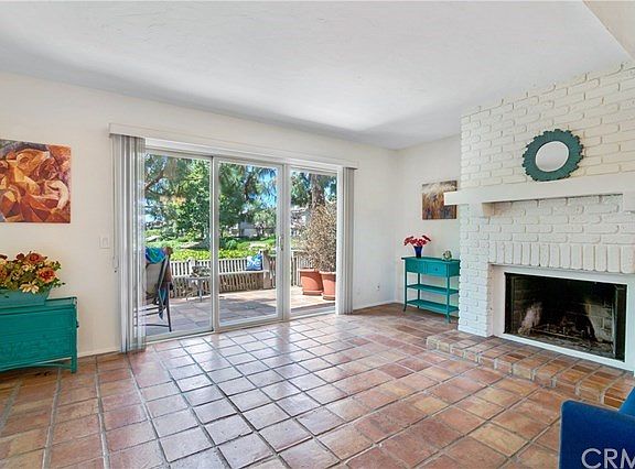 Living area with views to lushly landscaped grounds and pond.