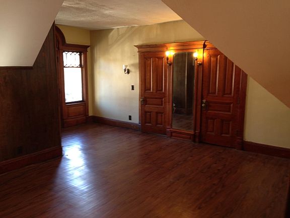 Open floor plan. Living area has a ceiling fan, fireplace a