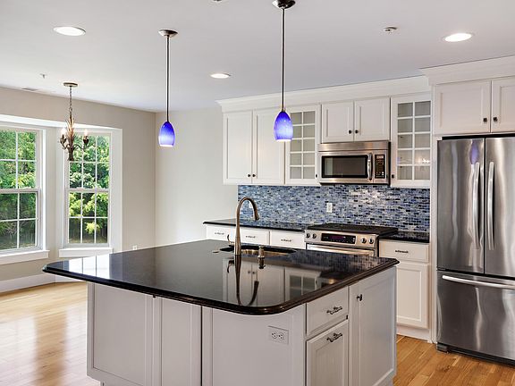 Informal dining faces treeline; ceiling height cabinets; quartz countertops