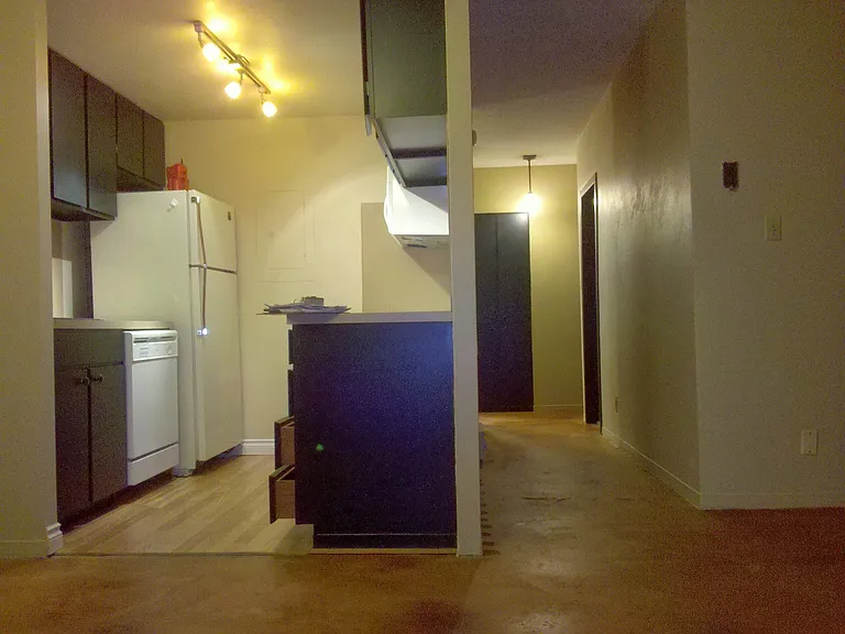 Looking from dining area at kitchen on the left and hallway on the right.