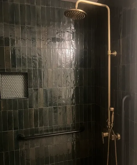 Guest bathroom with dual shower heads and safet
y grab bars.
