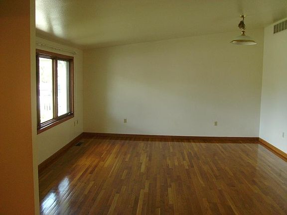 Spacious living room with real hardwood floors and lots of n