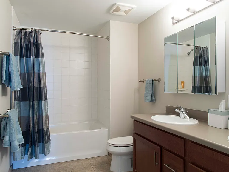 Our bathrooms feature a clean and modern design with a full-size tub and shower, perfect for relaxing and refreshing.